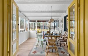 a dining room with a table and chairs at Nice Home In Vig With Sauna in Vig