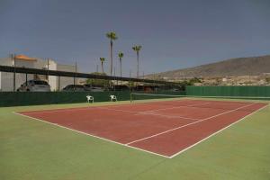 a tennis court with two chairs on it at 2 bedrooms appartement with shared pool terrace and wifi at Costa Adeje in Santa Cruz de Tenerife