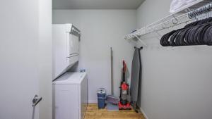 a room with a kitchen with a white wall at Landing Modern Apartment with Amazing Amenities (ID8369X10) in Omaha