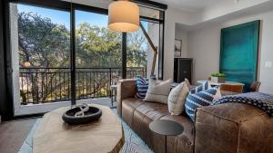 a living room with a couch and a large window at Landing Modern Apartment with Amazing Amenities (ID9506X79) in Houston