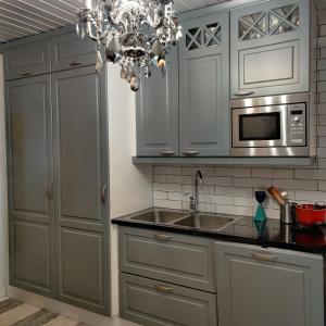 a kitchen with a sink and a microwave at Luukkaan Helmi in Lappeenranta +23 photos