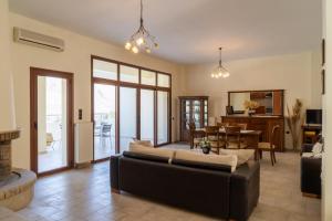 a living room with a couch and a dining room at House of Papadogiannis in Akoumia