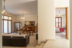 a living room with a couch and a dining room at House of Papadogiannis in Akoumia