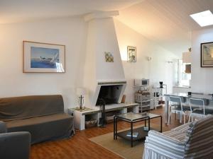 a living room with a couch and a fireplace at Maison Les Portes-en-Ré, 3 pièces, 6 personnes - FR-1-434-18 in Les Portes