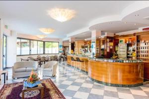 a lobby with a bar and a restaurant at Hotel President in Cesenatico