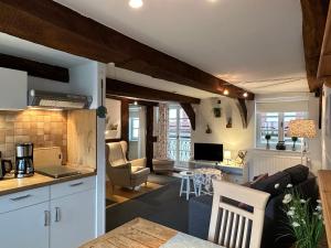 a kitchen and a living room with a kitchen and a living room at Wohnen auf der historischen Stadtmauer im Herzen von Detmold in Detmold