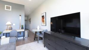 a living room with a large flat screen tv at Landing Modern Apartment with Amazing Amenities (ID5061X74) in Portland