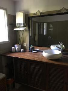 a bathroom counter with a sink and a mirror at Nico Zen Home in Vendargues