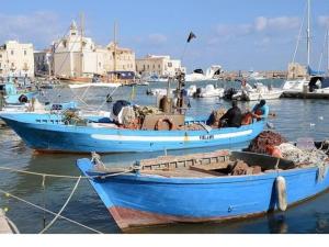 two blue boats are docked in a harbor at Residence Lori in Brindisi
