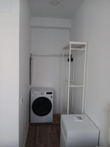 a laundry room with a washing machine and a shelf at Francos Rodriguez1 Apartments in Madrid