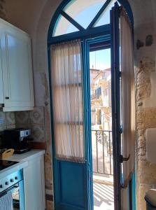 パノルモス・レティムノにあるVilla Aposperitisの青いドアと窓のあるキッチン