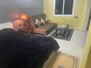a bedroom with a bed and a couch and a table at Beautifull Studio@ City Centre in Fez