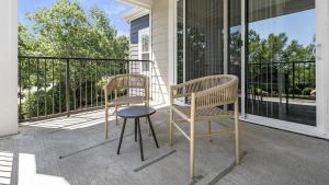 two chairs and a table on a porch at Landing Modern Apartment with Amazing Amenities (ID1375X099) in Charlotte