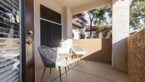 two chairs and a table on a balcony at Landing Modern Apartment with Amazing Amenities (ID8102X91) in Phoenix