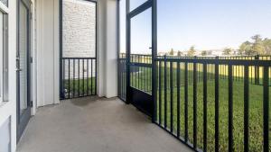 a balcony with a gate with a view of a yard at Landing Modern Apartment with Amazing Amenities (ID9455X92) in Middleburg