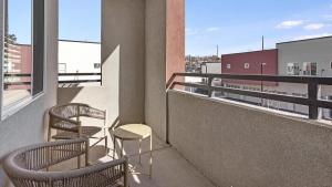 a balcony with two chairs and a table on a building at Landing Modern Apartment with Amazing Amenities (ID7745X98) in Albuquerque