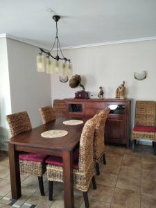 a dining room with a wooden table and chairs at 3 bedrooms apartement at Bronchales in Bronchales