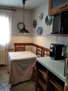 a kitchen with a table and a microwave on a counter at 3 bedrooms apartement at Bronchales in Bronchales