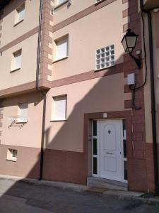 a building with a white door on the side of it at 3 bedrooms apartement at Bronchales in Bronchales