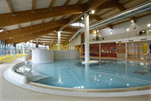 a large swimming pool in a large building at Jurtovna in Beroun