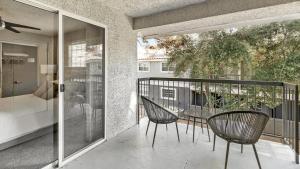 a patio with chairs and a table on a balcony at Landing Modern Apartment with Amazing Amenities (ID4301X28) in Las Vegas