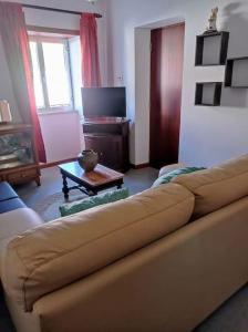 a living room with a couch and a table at Casa da Calçada - Piso 1 in Seia