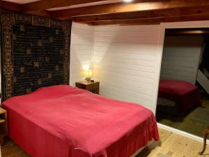 a bedroom with a red bed in a room at Lakeside Hideaway Cabin in Bursa