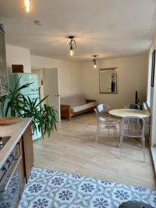 a living room with a table and chairs and a couch at Beautiful canal-view apartment in London