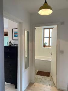 a bathroom with a tub and a sink and a mirror at Beautiful canal-view apartment in London