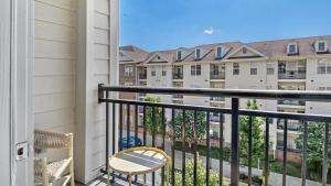 a balcony with a chair and some buildings at Landing Modern Apartment with Amazing Amenities (ID8354X41) in Leesburg