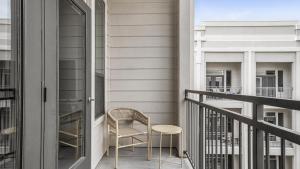 a balcony with a chair and a table at Landing Modern Apartment with Amazing Amenities (ID9564X38) in Houston