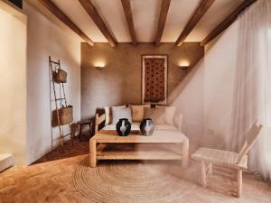 a living room with a couch and a table at The Wild by Interni in Kalafatis