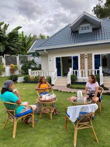 a group of women sitting around a table in a yard at Sunshine's Haven in Ronda