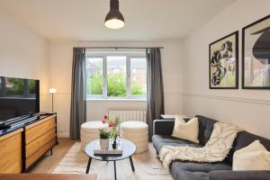 a living room with a couch and a table at The Hackney Place - Spacious 1BDR Flat in London