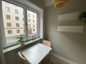 a white table in a room with a window at Cozy one bedroom apartment in Stockholm in Stockholm
