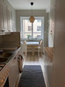 a kitchen with a table and a dining room at Cozy one bedroom apartment in Stockholm in Stockholm