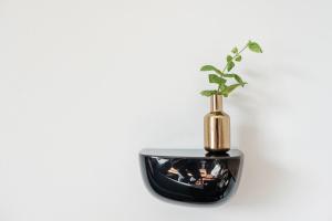 a vase with a plant on top of a table at Suite Franz Tegernsee in Tegernsee