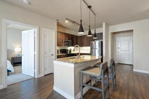 a kitchen with a sink and a counter top at Landing Modern Apartment with Amazing Amenities (ID3876) in Carrollton