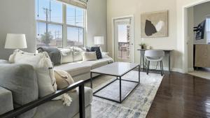 a living room with a couch and a table at Landing Modern Apartment with Amazing Amenities (ID3512X6) in El Paso