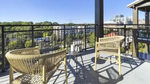 two chairs and a table on a balcony at Landing Modern Apartment with Amazing Amenities (ID1228X214) in Greenville