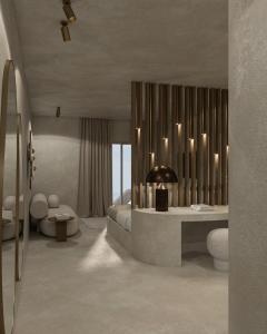 a room with a bed and a table with candles at Andronis Concept Wellness Resort in Imerovigli