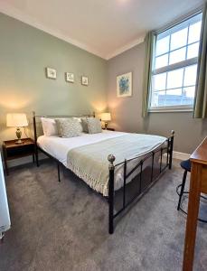 a bed in a bedroom with a large window at The Windmill Hotel - Alford in Alford