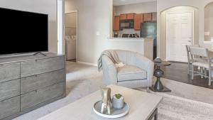 a living room with a flat screen tv and a couch at Landing Modern Apartment with Amazing Amenities (ID9979X33) in Carmel