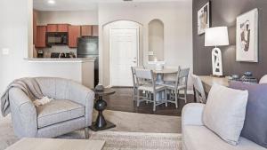 a living room with a table and chairs and a kitchen at Landing Modern Apartment with Amazing Amenities (ID9979X33) in Carmel