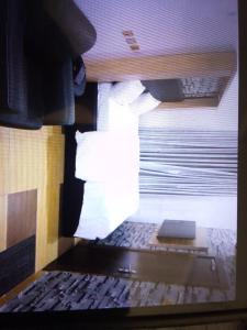 a view of a bed in a room with a window at Sanzak hotel and apartments in Lagos