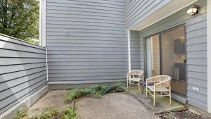 two chairs sitting on the side of a house at Landing Modern Apartment with Amazing Amenities (ID7684X1) in Lexington