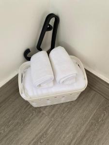 a basket with towels in the corner of a room at LuckySmallie 1-Bed Apartment in Goba Dar es Salaam in Dar es Salaam