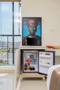 a tv sitting on top of a refrigerator at PRESIDENCY AIRPORT HOTEL in Cochin