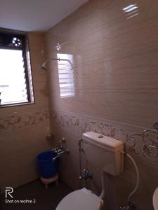 a bathroom with a toilet and a window at SALAS EXECUTIVE in Mahabaleshwar