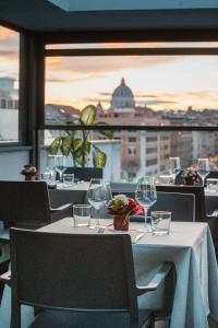 a table with wine glasses and a view of a city at Twentyone Hotel in Rome